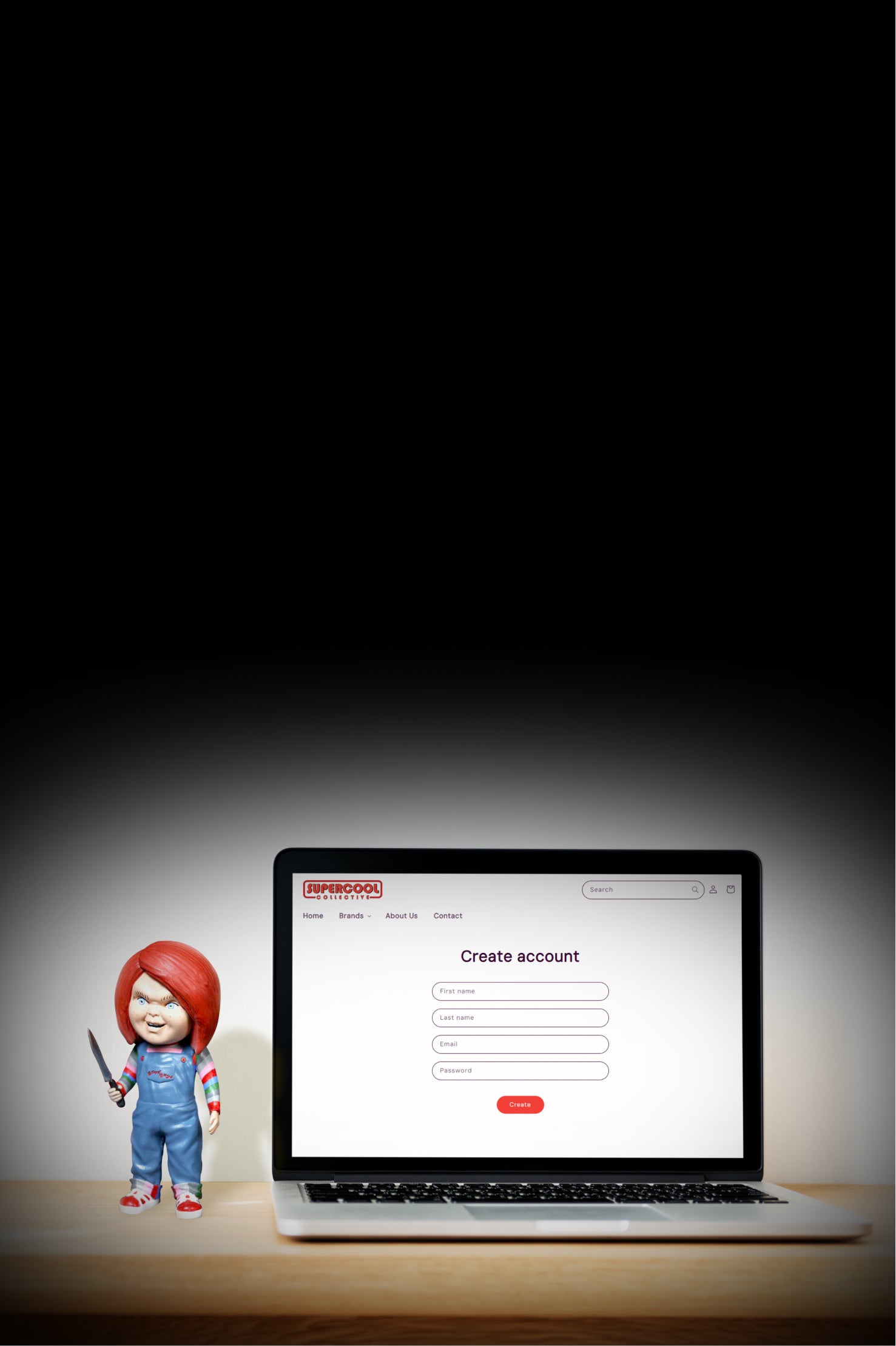 Laptop displaying a 'create account' page, with a Chucky figure holding a knife on a desk.