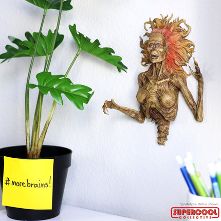 Half-Corpse Status hung on a white wall, shown with a vase with a sticky note that says "# more brains!"