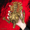 Half-corpse statue held by a hand with black nails.